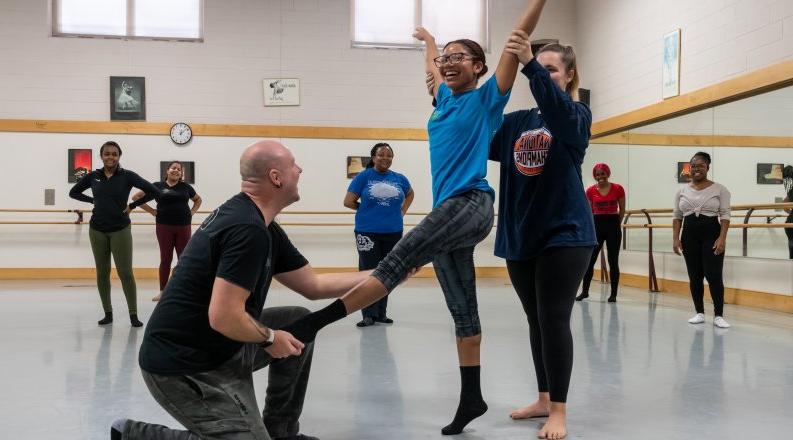 Instructor assists dance student at Pre-Collegiate Summer Dance Intensive.